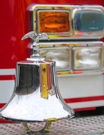 American fire truck fire engine with gleaming eagle symbol above the bell