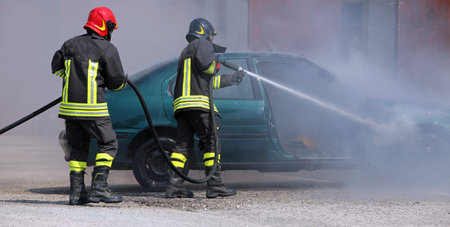 Firefighters extinguished the fire at a car after the traffic accident