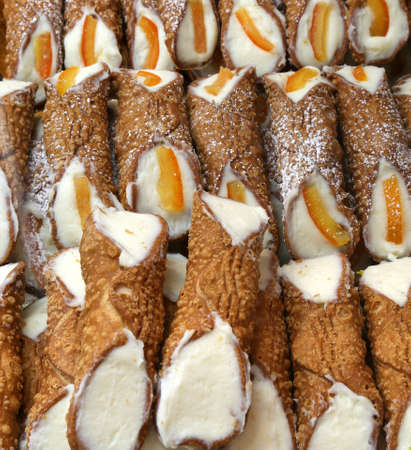 Sicilian pastry with many cannoli with ricotta cheese and slices of  orangeの写真素材