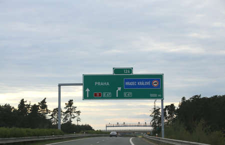 Highway sign with directions to reach the city of Prague in Czech Republicの写真素材