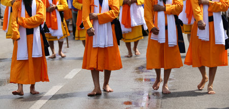 barefoot men of Sikh religions they walk through the streets of the city