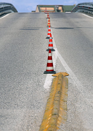 road with a steep climb without cars with traffic cones to mark lanes