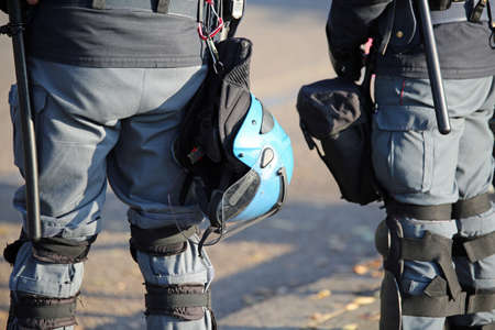 police in riot gear with protective helmet during the urban revolt of the protesters in the cityの写真素材