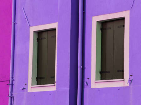 two  balconies of a colorful house on the island of Burano near Venice in Italyの写真素材