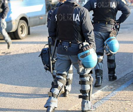 Italian police in riot gear with flak jackets and protective helmets and batons billyの写真素材