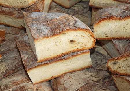 hunks of homemade bread cooked in a wood oven on sale in market stall