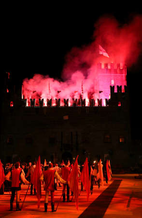 Marostica, VI, Italy - September 9, 2016: fireworks display with people in costume in the square and the fire in medieval castleのeditorial素材