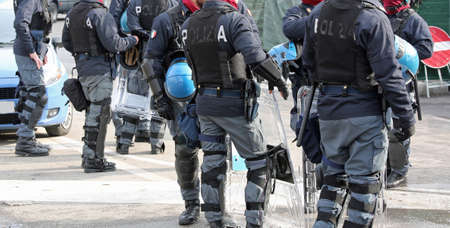 group of police with shields and riot gear during the event in the cityの写真素材