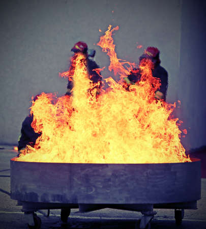 firefighters during the test of a fire extinguishing caused by a liquid gas spillの写真素材