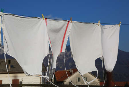 freshly washed white aprons they dry in the hot sun in a village in the mountainsの写真素材