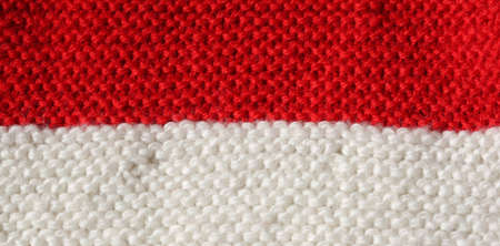 background of Red and White wool of a dress made by handの写真素材