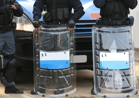 many policemen with shields and riot gear during the sporting event in town