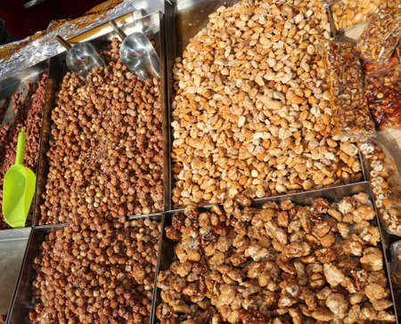 toasted peanuts and covered with cooked sugar for sale at the marketの写真素材