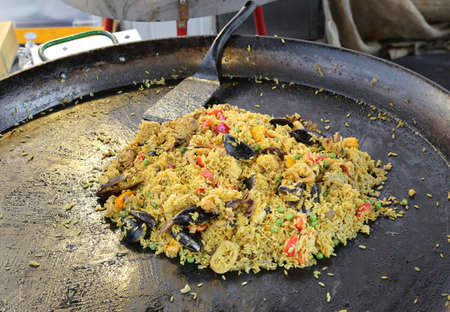 large pan of Spanish restaurant with tasty paella with rice and mussels and seafoodの写真素材
