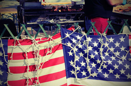 American flags in the street food stall while the cook prepares meatの写真素材