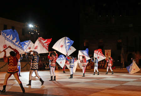 Marostica, VI, Italy - September 9, 2016: flag bearers during night show with Evolutions of big flagsのeditorial素材