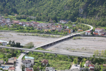aerial view of a long bridge and dried river without water