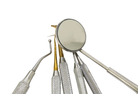 Many dental tools for cleaning the teeth and checking the caries with the round little mirror on...