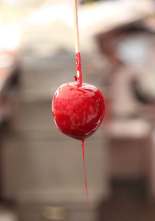 caramelized red apple with stick
