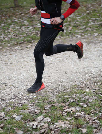 Athlete runs fast with long strides during the triathlon race with black sportswearの写真素材