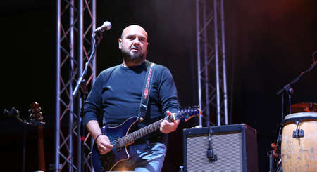 Foto de Bassano del Grappa, VI, Italy - April 29, 2017: Reggioli Sergio of Nomadi an Italian Musical Group plays the electric guitar during a live concert - Imagen libre de derechos