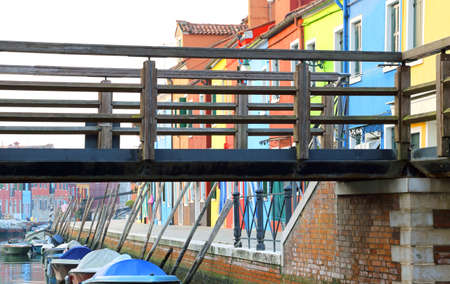 Bridge over the waterway near the colorful houses of the island of Burano near Venice in Italyの写真素材