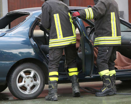 Firefighter training to extract trapped man in the car after the road accidentのeditorial素材