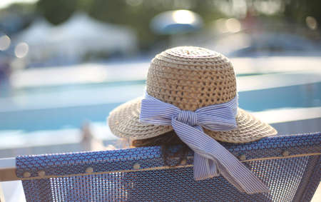 Young woman with straw hat sunbathing in the exclusive spaの写真素材