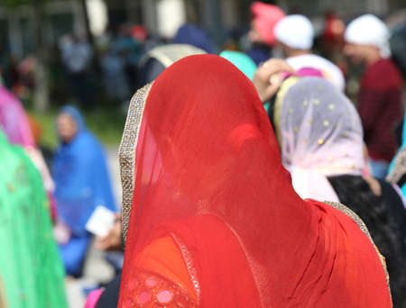 Young Woman with the veil over her heads during a religious event on the streets of the cityの写真素材