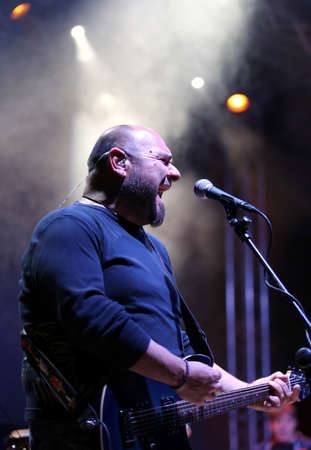 Foto de Bassano del Grappa, VI, Italy - April 29, 2017: Reggioli Sergio of Nomadi an Italian Musical Group plays the guitar and sings during a live concert - Imagen libre de derechos