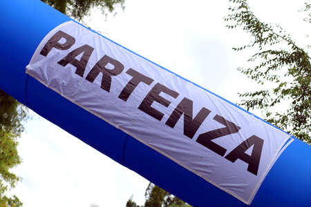 Large inflatable portal with the Italian Written PARTENZA which means Departing before the Competitive Raceの写真素材