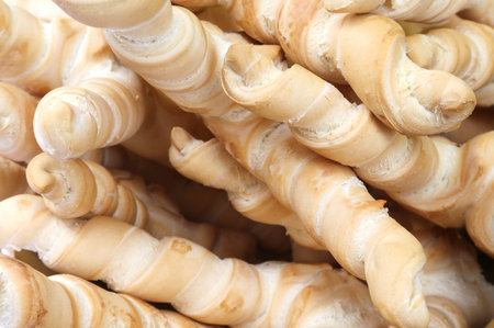 Background of honey-shaped bread loaves for sale in bakery