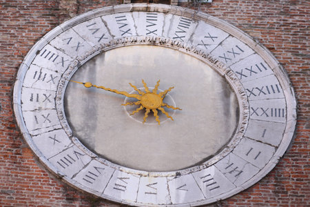 Ancient clock with one hand to measure the hours and Roman numerals on the clock dial on the island...