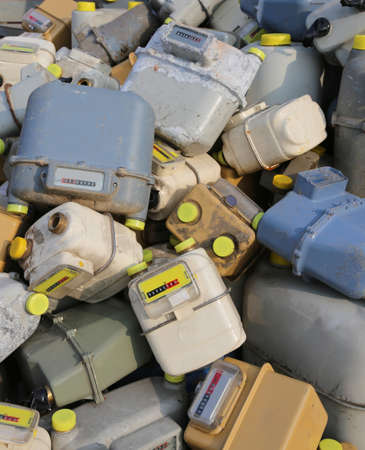 many discharged gas meter counters into a dump of hazardous and polluting materialの写真素材