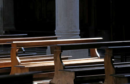 Old wooden bench with seat inside a churchの写真素材