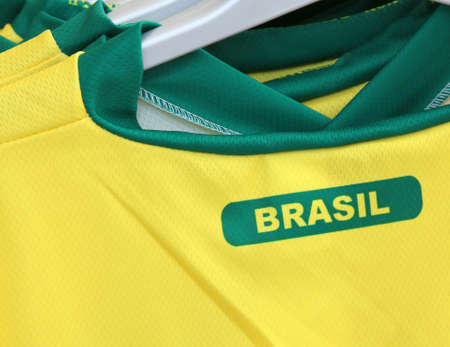 Football t-shirts with the text BRASIL which means Brazil for sale in the specialized sports shopの写真素材