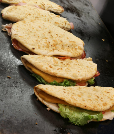 flatbread made with made with white flour olive oil salt and water cooked on the hot plate of the...