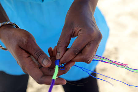 hand of african woman while make a braid with wireの写真素材