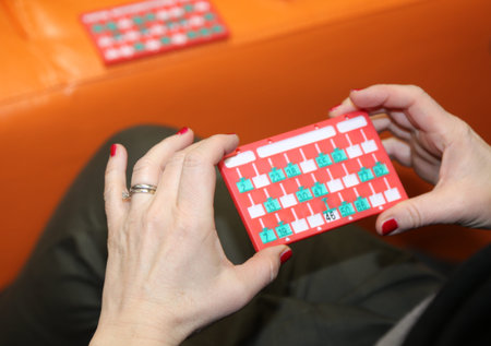 bingo scorecards and the hand of a woman player