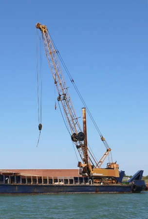 Giant cranes at a shipyard for the construction of a dam on the seaの写真素材