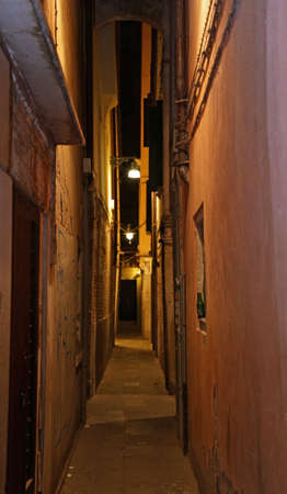 vedry narrow venice street called CALLE in Italian at night with a lamppostの写真素材
