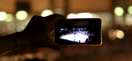 hand with the modern smartphone while shooting a video of a showの写真素材