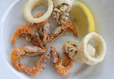 Fried fish with shrimp and a yellow lemon slice