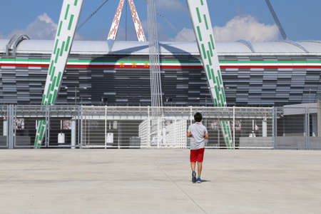 Torino, TO, Italy - August 26, 2016: Outside of the very popular stadium called Juventus Stadium
 and a boyのeditorial素材