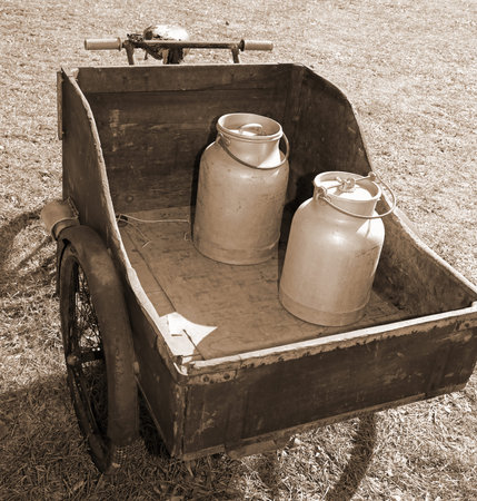 old bike with milk canister used once a long time ago from the milkman to deliver the fresh milk to...