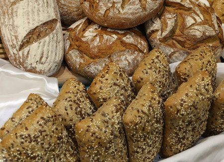 baked bread pieces made with whole wheat flour and seeds and cereals aboveの写真素材