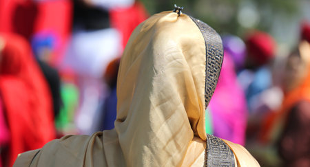 woman with golden veil during a religious event on the streets of the city