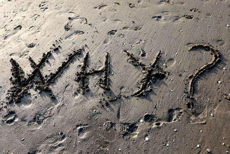 great inscription WHY on the beach sand near the seasideの写真素材