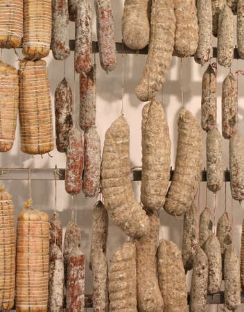 salami and cold meats and sausages for sale at the delicatessenの写真素材