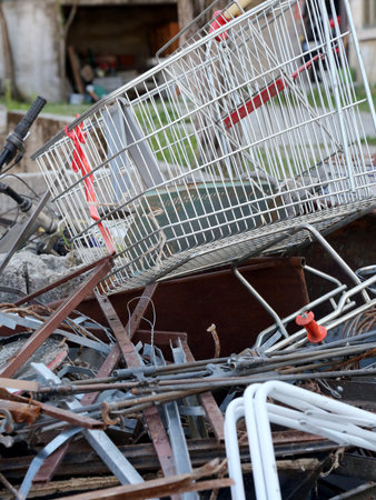 rusty old shopping cart in recycling of ferrous material for disposal